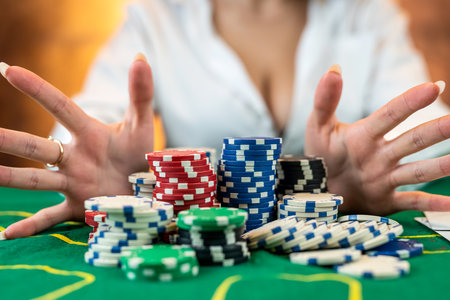 woman in a casino with chips that she wraps after a big win in casino poker. poker concept. the woman wins. isolatedの写真素材
