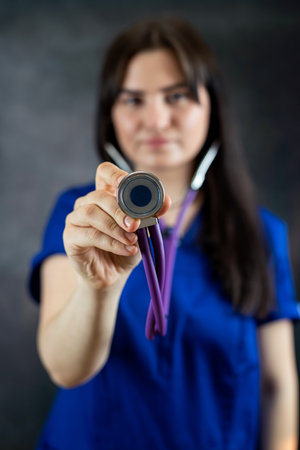 Portrait of happy young caucasian medical student or nurse in blue uniform with stethoscope. Medical concept, healthcareの写真素材