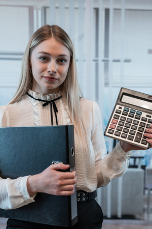 Businesswoman shows calculator at office. Female manager, analysis statistic concept