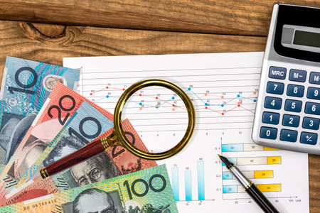 australian dollar with graph calculator on table.の写真素材