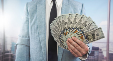 male hands counting dollar banknotes at office. rich conceptの写真素材