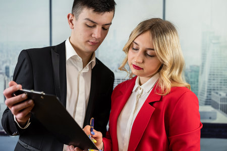 Meneger shows colleague sales chart and discussing business plan strategy at office. Meeting conceptの写真素材