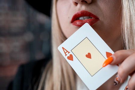 Young caucasian woman holding aces close up near red lips. Pokerの写真素材