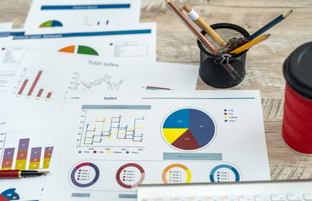 many business charts and graphs on office desk. Paperwork, analyzing gathering data, accounting...