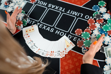 female croupier's hands are taking play card at poker table in casino. Gambling conceptの写真素材