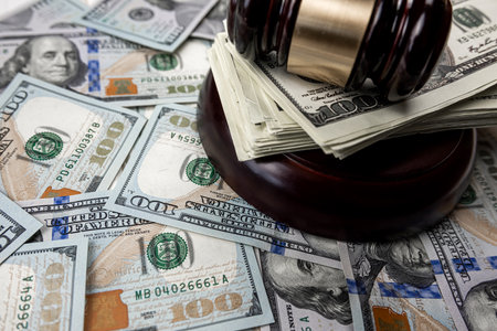 100 dollar bills with judge hammer. legal or crime concept, law