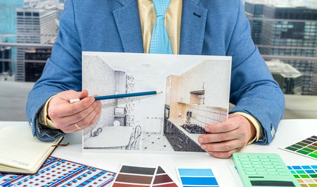 designer man man chooses colors for office work on apartment drawing. The choice of colors in the drawing of the apartment. Hands of designer manの写真素材