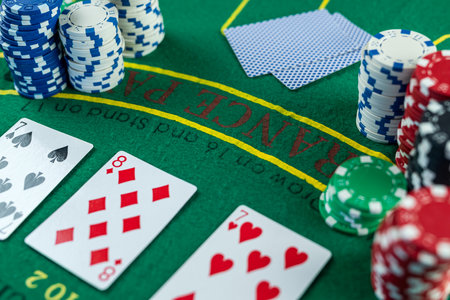 Poker cards with three of a kind or set combination. Close up of gambler hand takes playing cards in...
