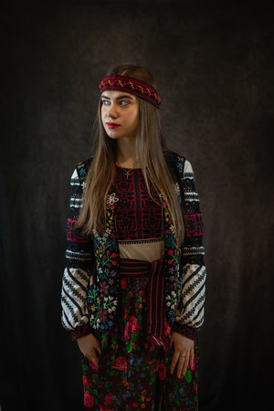 The young Ukrainian woman worn the traditional outfit of embroidery and poses in the studio. Fashion clothの写真素材