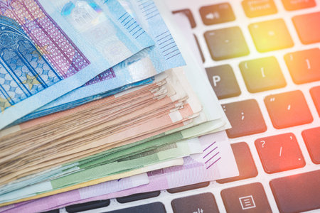 Different Euro paper notes on keyboard computer. Purchase finance conceptの写真素材