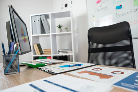 Stylish workplace, nobody desk with business paper diagram pen calculator computer, project statisticsの写真素材