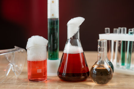 Glass laboratory flask and beaker with liquids for analys or experiment in desk. Chemical...
