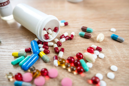 Many different pills with bottle on wooden table, health background. Medicinal tablets or vitamins