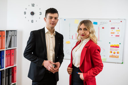 Portrait of two happy young business workers in suit at the office. Teamworkの写真素材
