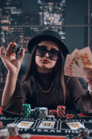 Excited young woman playing poker at casino. Luck and fortune for big win, blackjackの写真素材