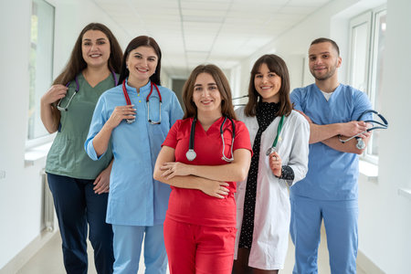 Caucasian medical students wear uniform in corridor of modern clinic. Doctors portrait in healthcare missionの写真素材