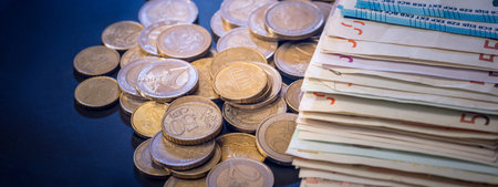 pile of different paper euro banknotes and coins cent. Saving concept