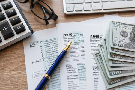 PC keyboard US dollar pen 1040 tax form on office table desktop. Tax time conceptの写真素材