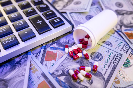 calculator US dollars bills with medical pills tablets. Concept of expensive costの写真素材