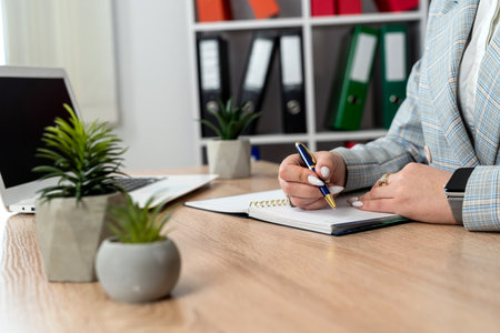 Freelance woman work with laptop and write in notepad at office. Distance jab conceptの写真素材