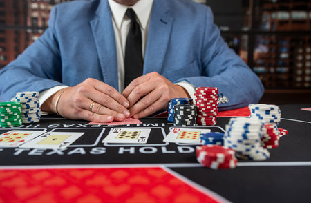 Male player hold poker card play a game for chance to win at casino.  Gambling concept. Luck and fortuneの写真素材