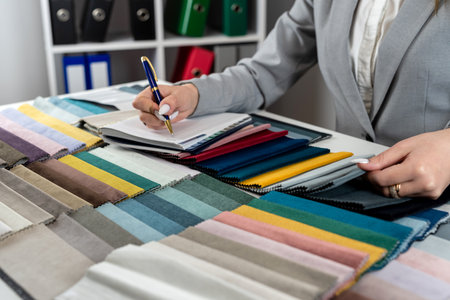 woman designer choose at tissue samples best bright color for a new furniture at home. Fabric samplerの写真素材