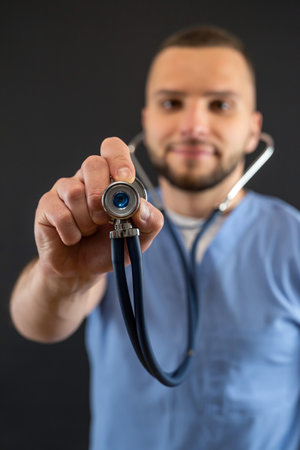 Young caucasian male doctor or nurse in blue uniform and stethoscope isolated. Medical staffの写真素材