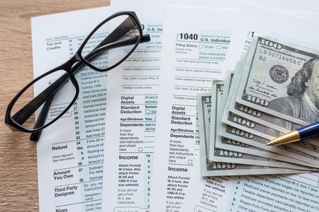 Form 1040 with pen and glasses, tax payment. Finance documentの写真素材