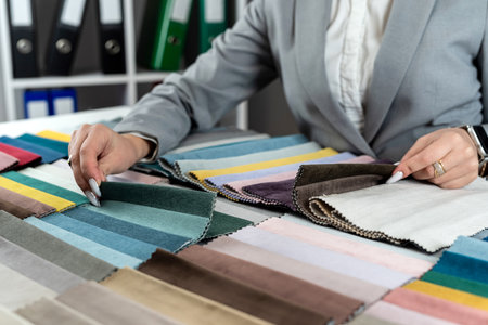 woman designer choose at tissue samples best bright color for a new furniture at home. Fabric samplerの写真素材