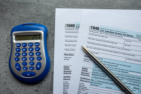 2023 tax return form 1040 with pen and calculator on desk. Tax time, business conceptの写真素材