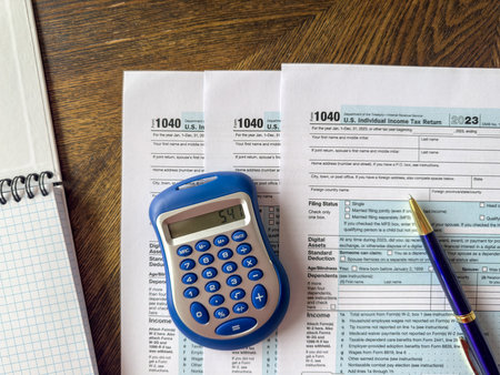 Tax deduction planning 1040 tax forms with calculator pen at office desk. Calculation tax return conceptの写真素材