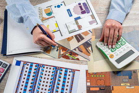 female designer drawing on architectural project at office. Creative people workplace