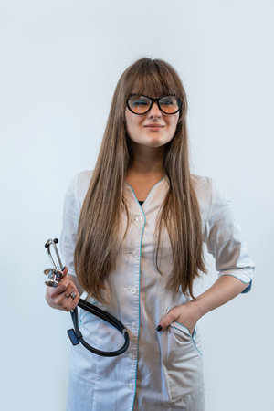 studio shoot female doctor wearing medical coat and stethoscope isolated on white grey background, hospital workerの写真素材