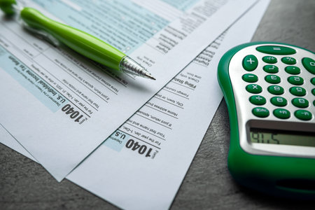 2023 individual tax return forms 1040 with pen calculator. Tax time concept