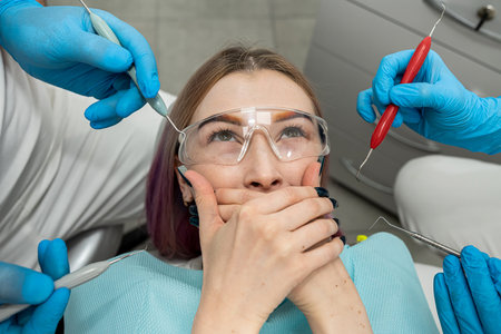 Upset woman with phobia having panic attack in clinic before treatment. dentistry fear.の写真素材