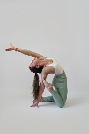 woman doing pilates workout at studio shot, gray background. Sport conceptの写真素材
