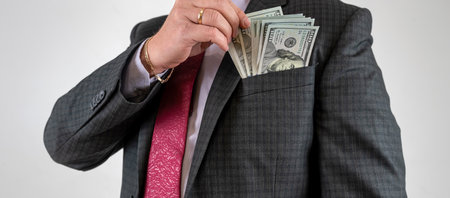 young businessman wear suit hold us dollar money. Finance concept
