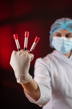 Researcher women nurse analyzing a tube with blood samples in laboratory. Healthca conceptの写真素材