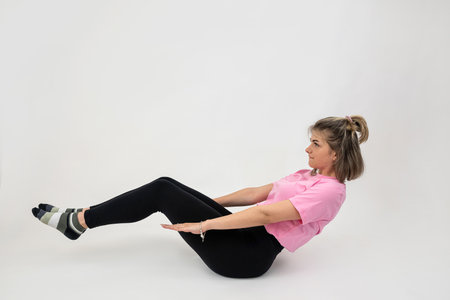 Fitness caucasian woman in sportwear make stretch exercise or workout isolated. Sport conceptの写真素材