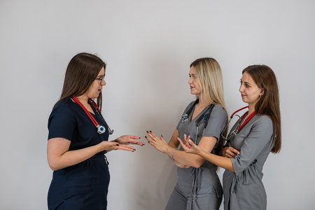 Group of three women doctors nurses wear uniform standing together isolated. Surgical teamの写真素材