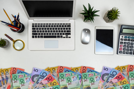 Australian dollar laptop notebook pen calculator on office desk. Financial conceptの写真素材