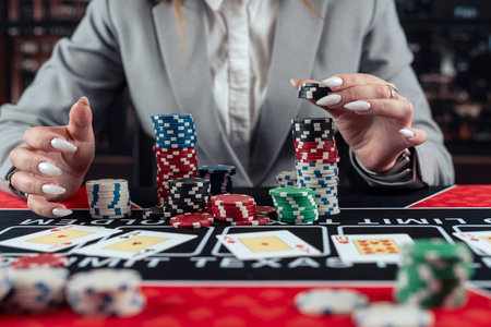 lucky woman playing poker at casino and increases the stakes, the risk for a big win, gambling conceptの写真素材