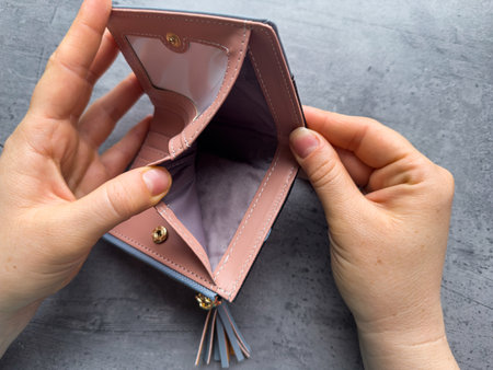 Poor woman open her empty wallet without money. Having financial problems bankruptcy concept.の写真素材