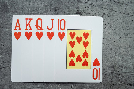 Set of Heart Royal flush playing cards on grey desk. Gambling conceptの写真素材