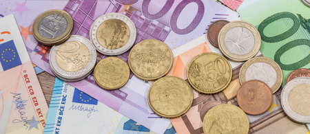 pile of different paper euro banknotes and coins cent. Saving conceptの写真素材