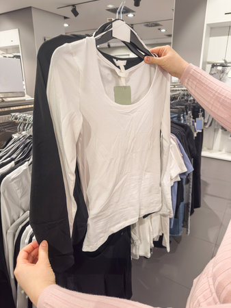 close up women look new collection of clothes in shopping mall. Shopping concept saleの写真素材