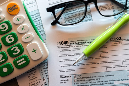 1040 Individual income tax form pen calculator and glasses ready to fill. Tax seasonの写真素材