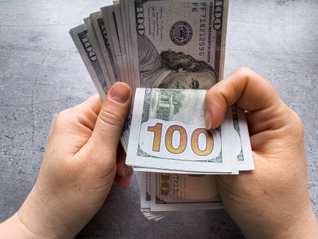woman count 100 dollar bill or cash with money laundering. Fraud, accounting and investment conceptの写真素材