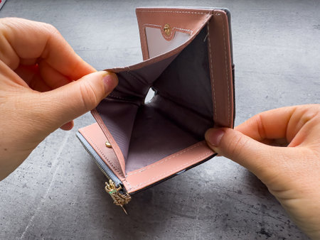 Poor woman open her empty wallet without money. Having financial problems bankruptcy concept.の写真素材