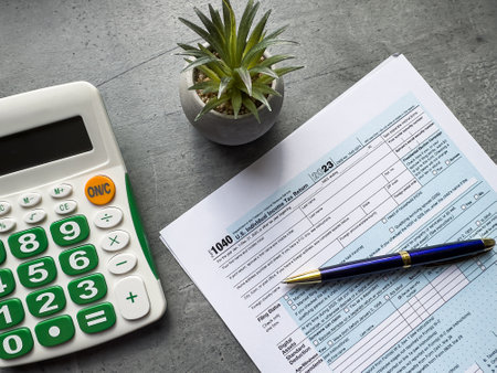 Tax accounting blank form pen and calculator on wooden table. Tax seasonの写真素材